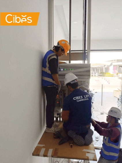 Cibes Lift Cambodia technicians installing a home lift inside a building.