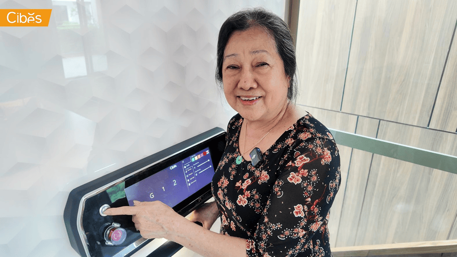 Elderly homeowner using a simple touch control inside a modern home elevator.