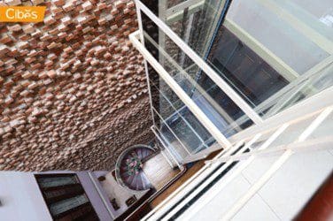 Cibes residential elevator with glass shaft in house